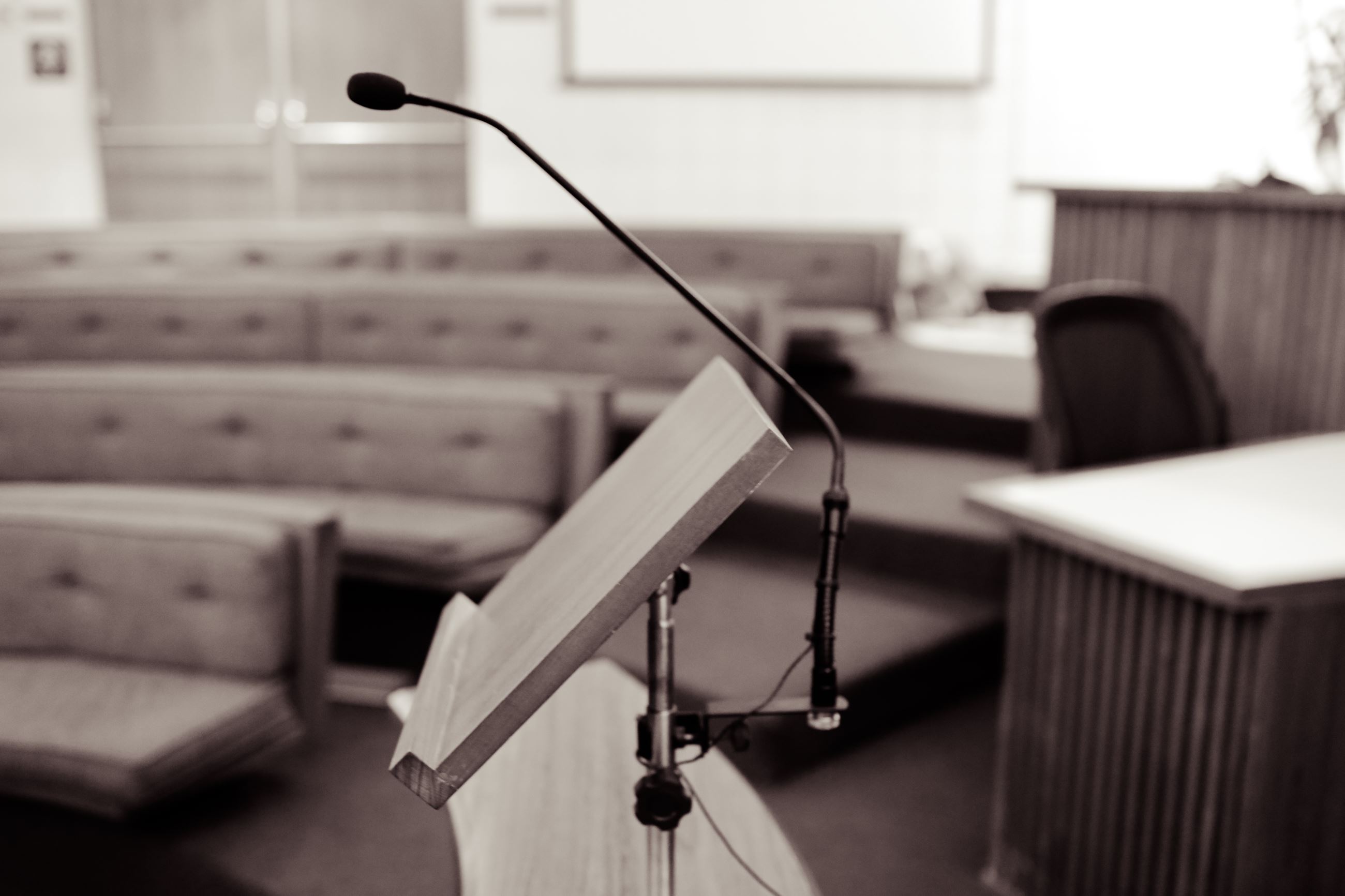 Microphone at podium with seats in the background